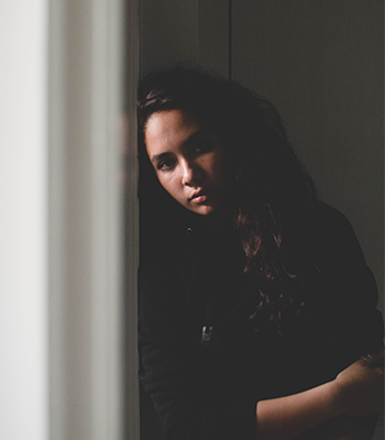 Woman leaning against a wall